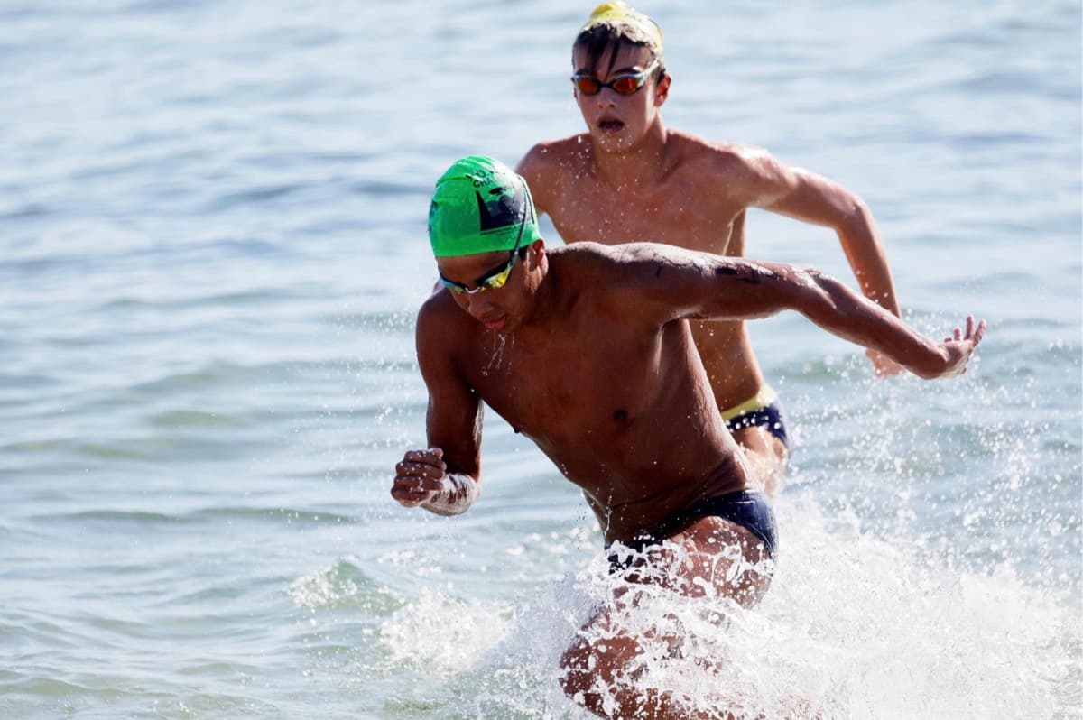 Swimmers sprinting out of water